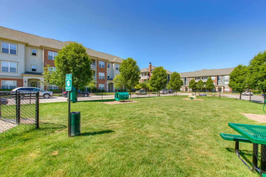 Enclosed dog park with waste container at apartment community